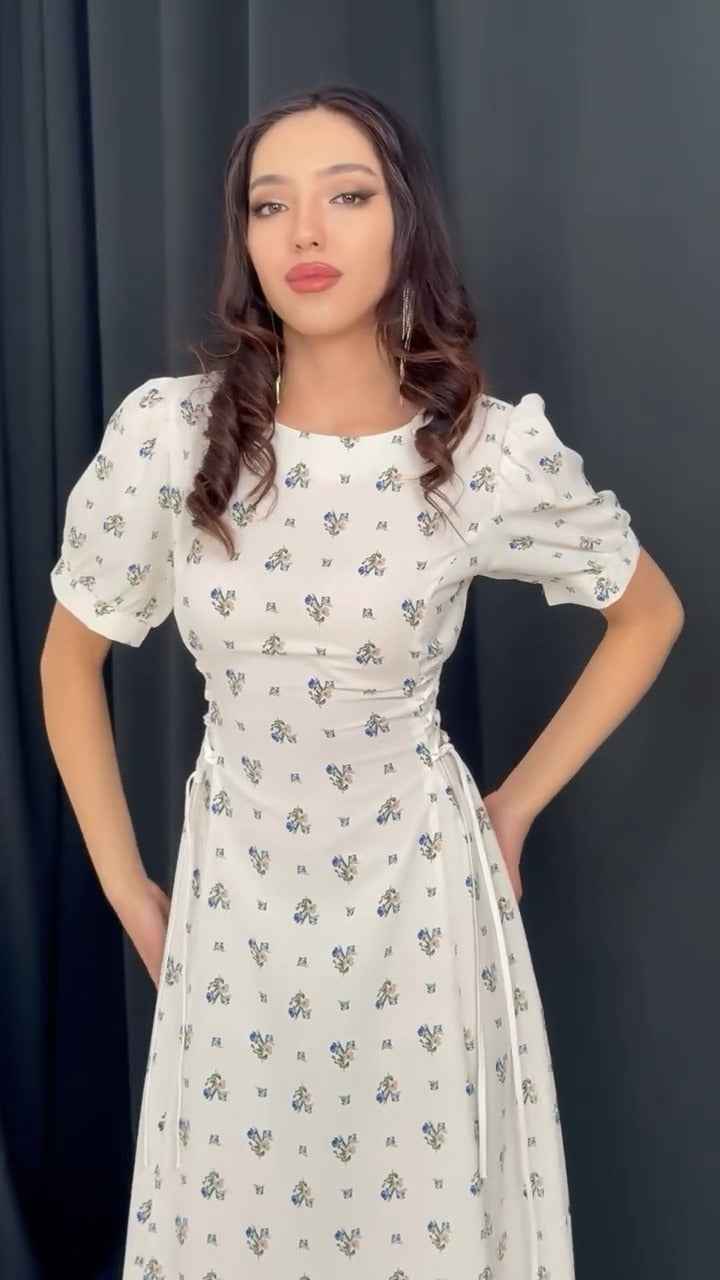 white midi dress with a blue floral print