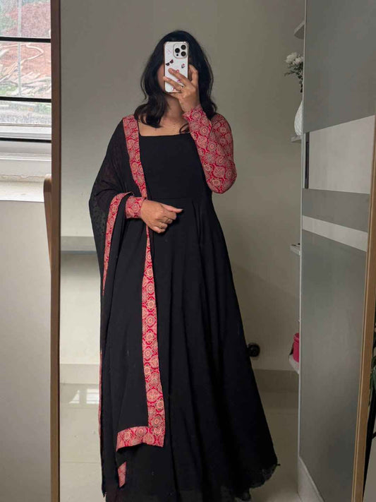 stunning portrait of a young woman exuding grace and poise in a traditional black Anarkali outfit.