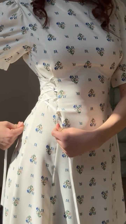 white midi dress with a blue floral print