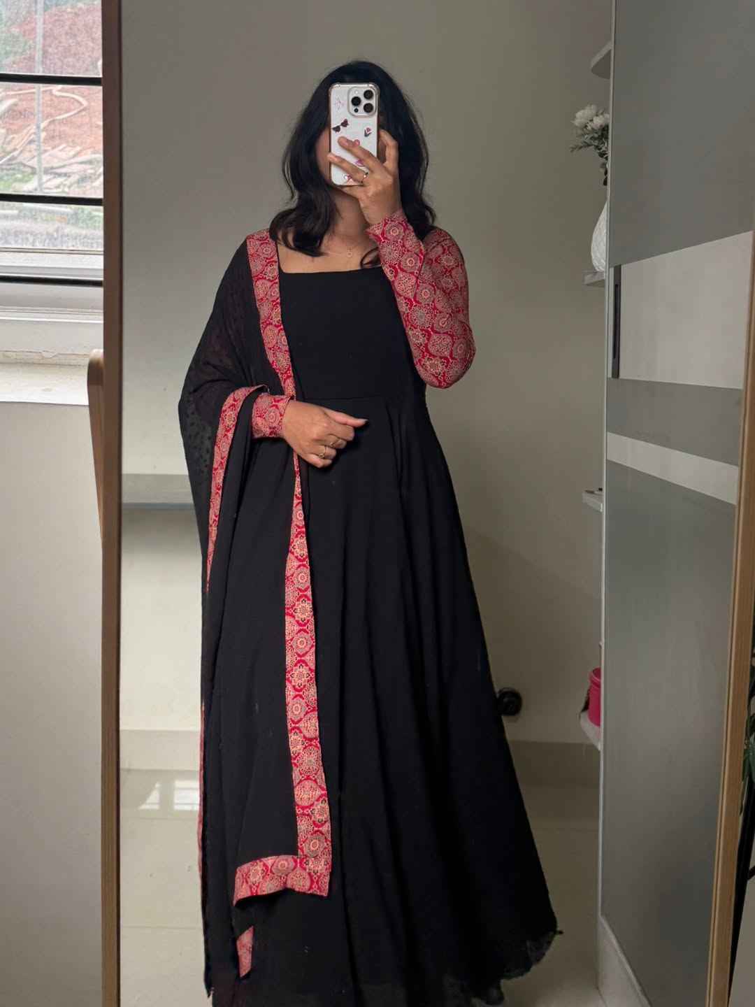 stunning portrait of a young woman exuding grace and poise in a traditional black Anarkali outfit.